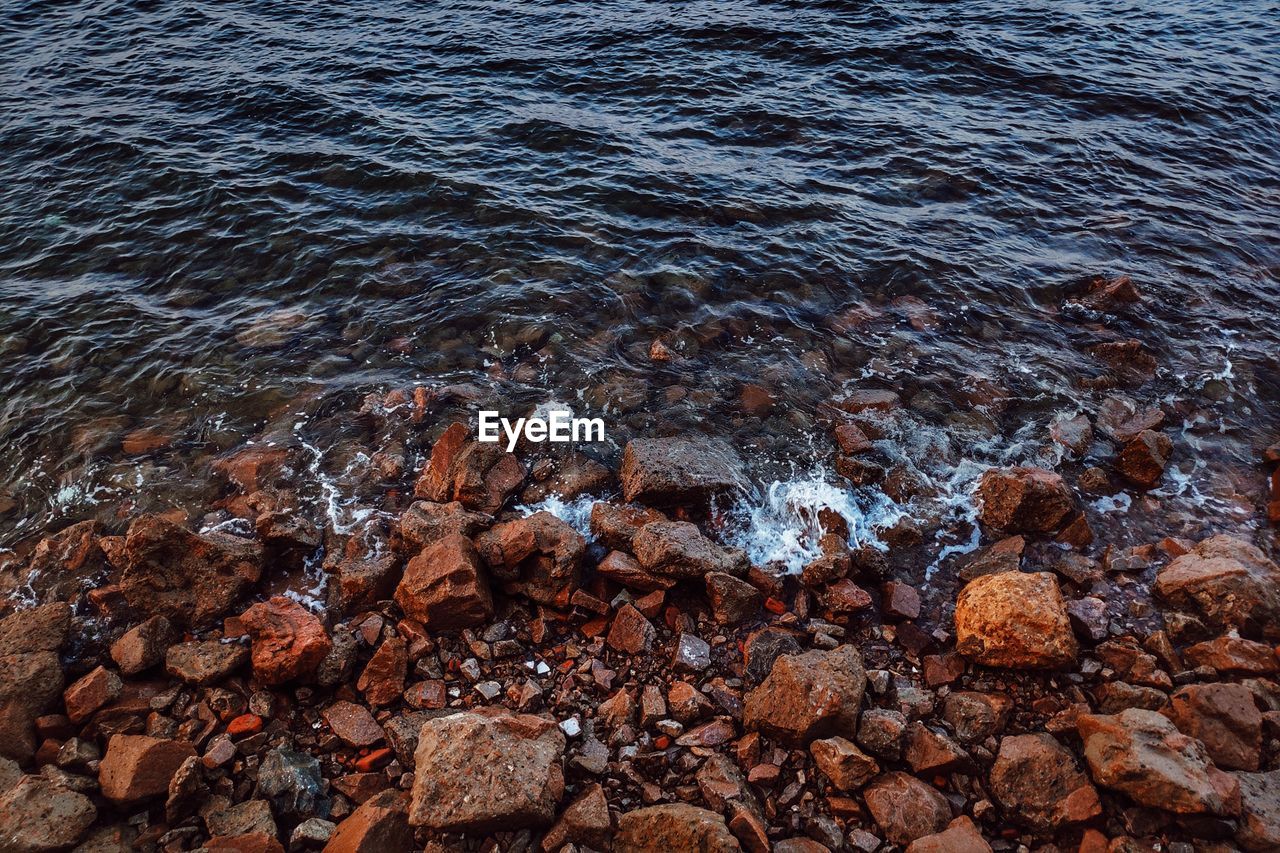 High angle view of rocks in sea