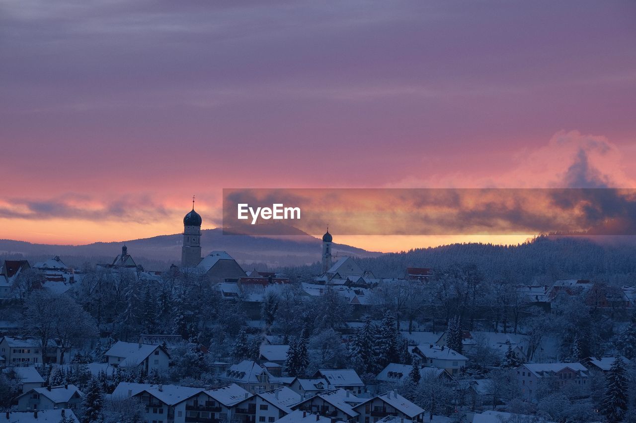 Townscape against sky during winter