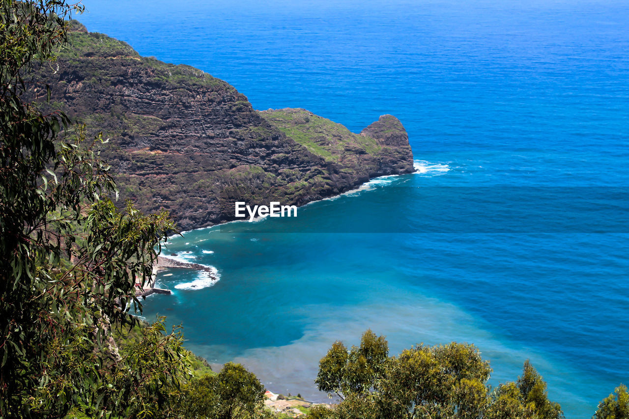 High angle view of bay against clear blue sky