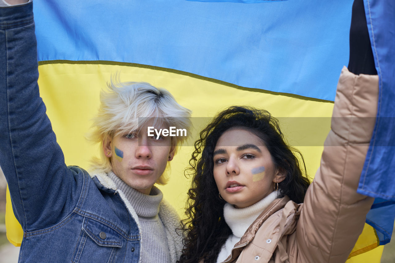 portrait of smiling woman holding flag