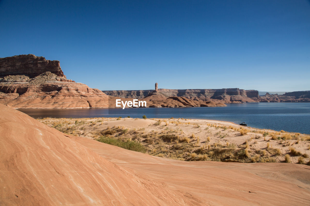 Scenic view of land against clear blue sky