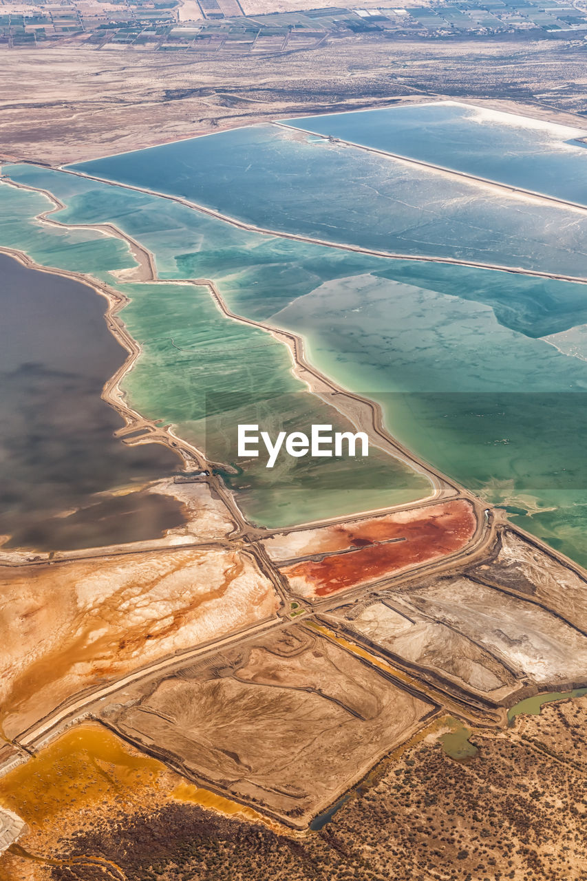 HIGH ANGLE VIEW OF WATER FLOWING FROM LAND