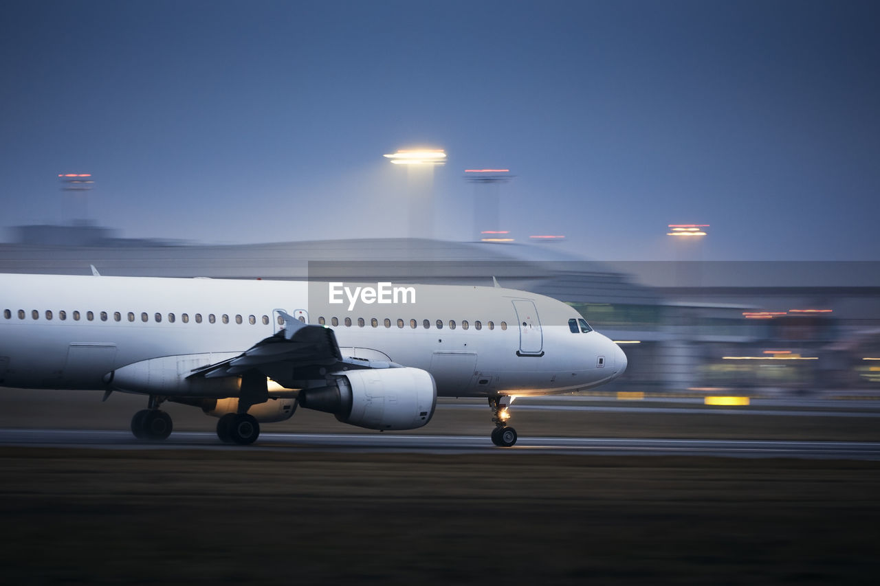 Airplane during take off on airport runway at night. plane in blurred motion at night.