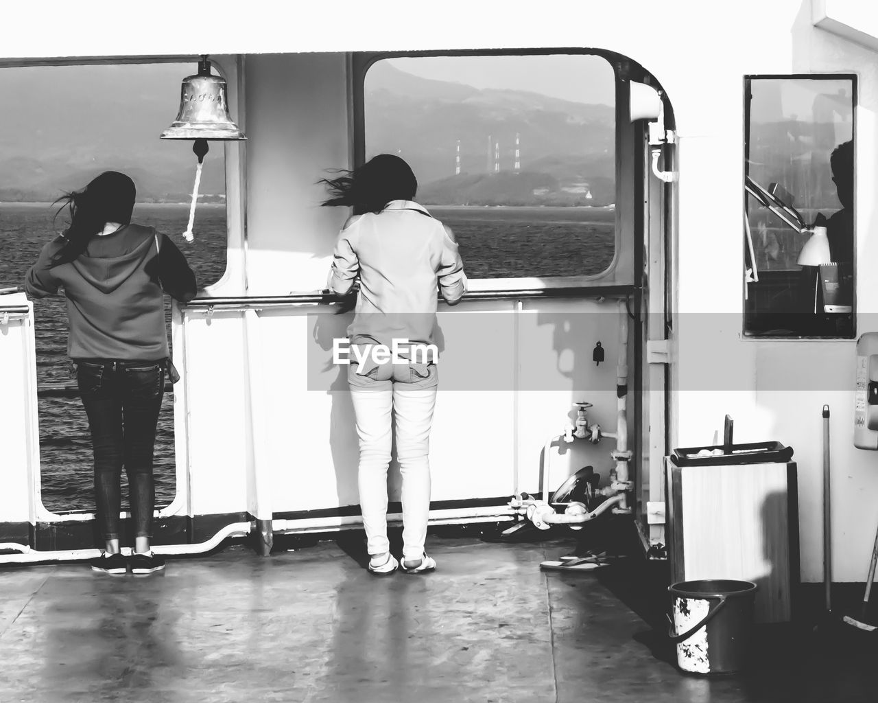 Rear view of woman standing on boat sailing in sea