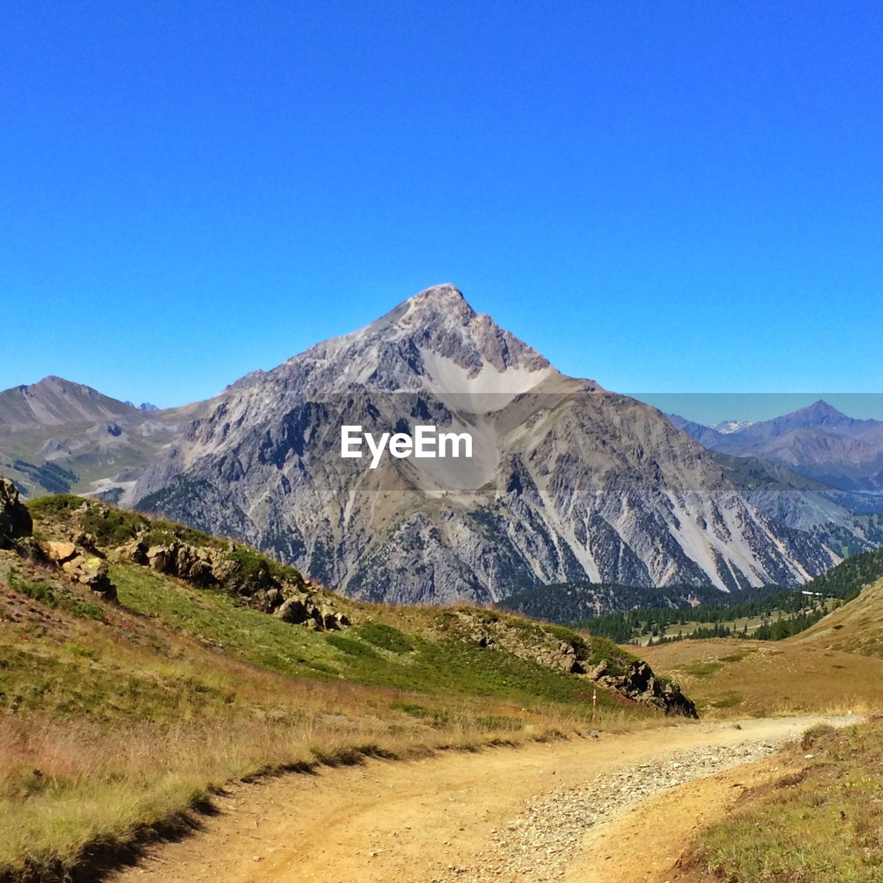 Scenic view of snowcapped mountains against clear blue sky