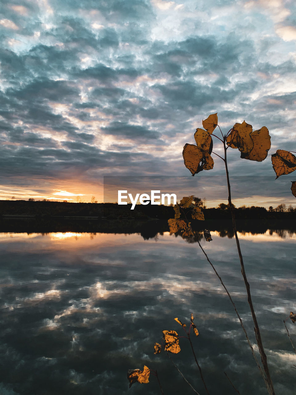SCENIC VIEW OF LAKE AGAINST ORANGE SKY