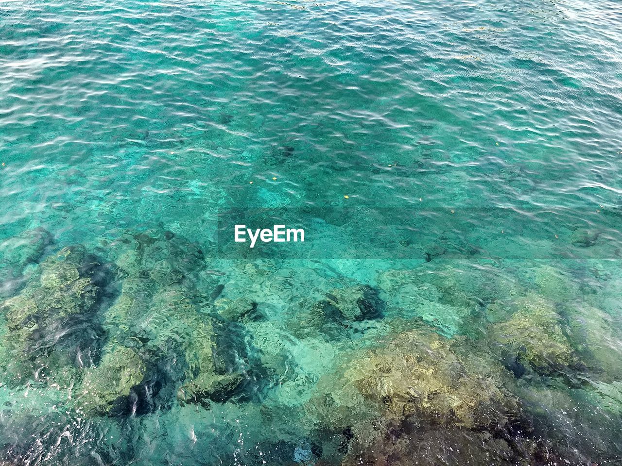 HIGH ANGLE VIEW OF RIPPLED WATER