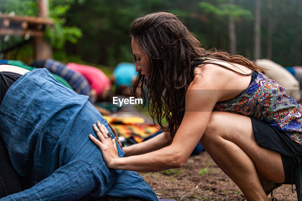 Midsection of woman sitting outdoors