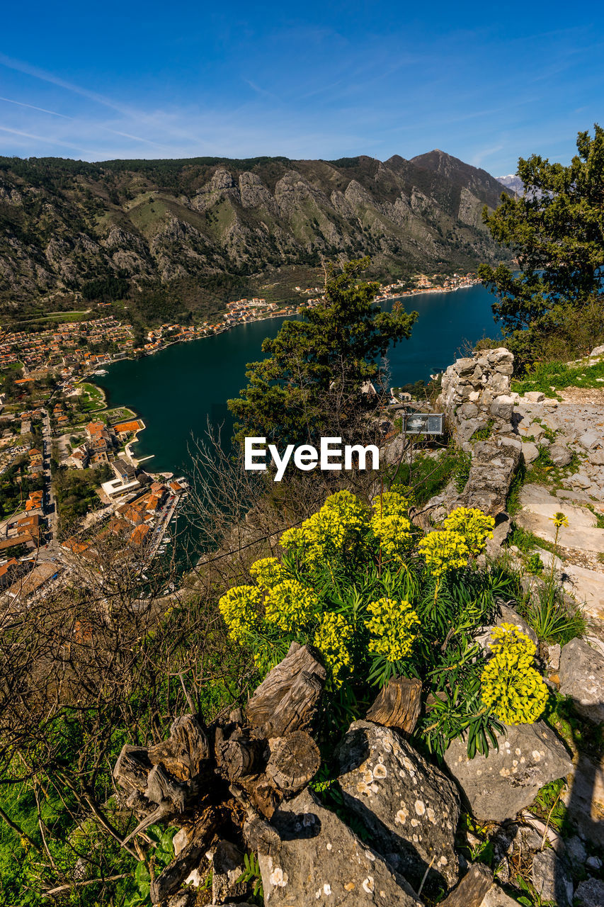 Scenic view of lake and mountains against blue sky