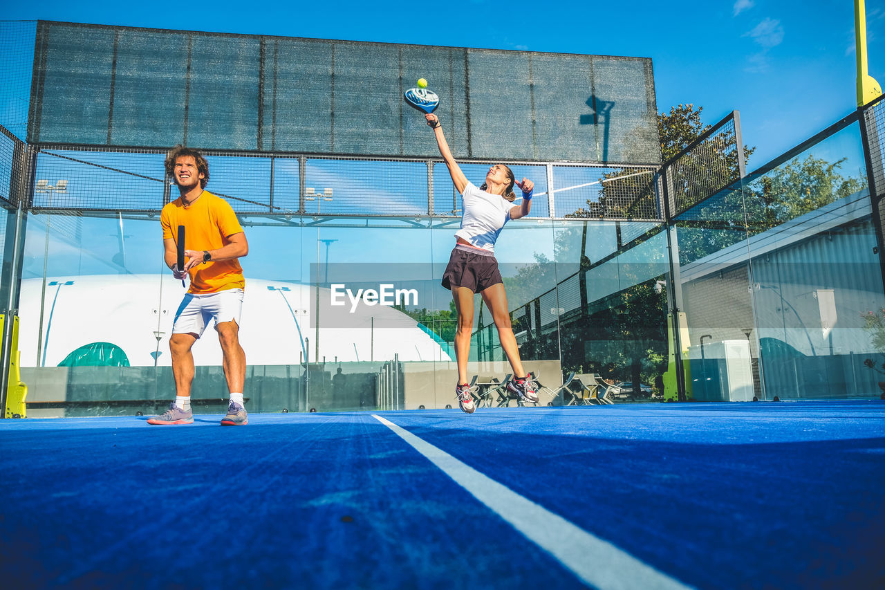 Low angle view of tennis players playing at court
