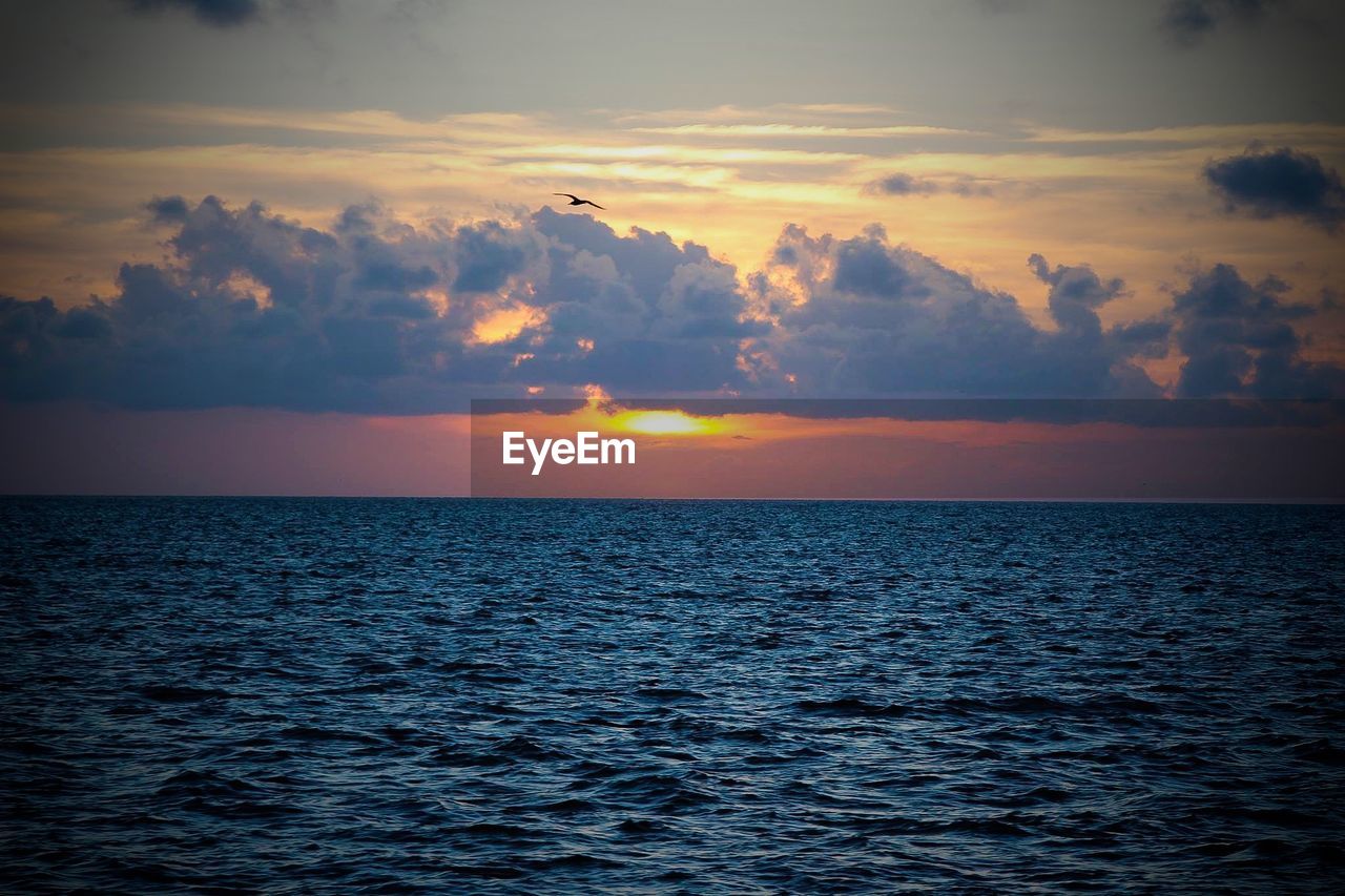 Scenic view of sea against sky at sunset