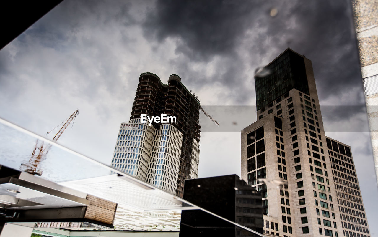 LOW ANGLE VIEW OF MODERN BUILDINGS AGAINST SKY