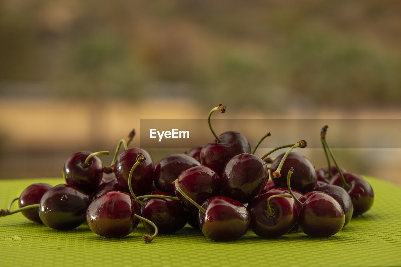 CLOSE-UP OF FRESH FRUITS ON TABLE
