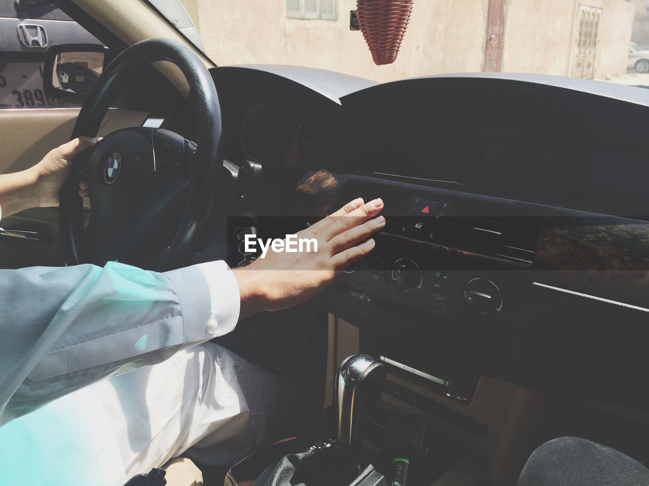 MIDSECTION OF MAN SITTING IN BUS