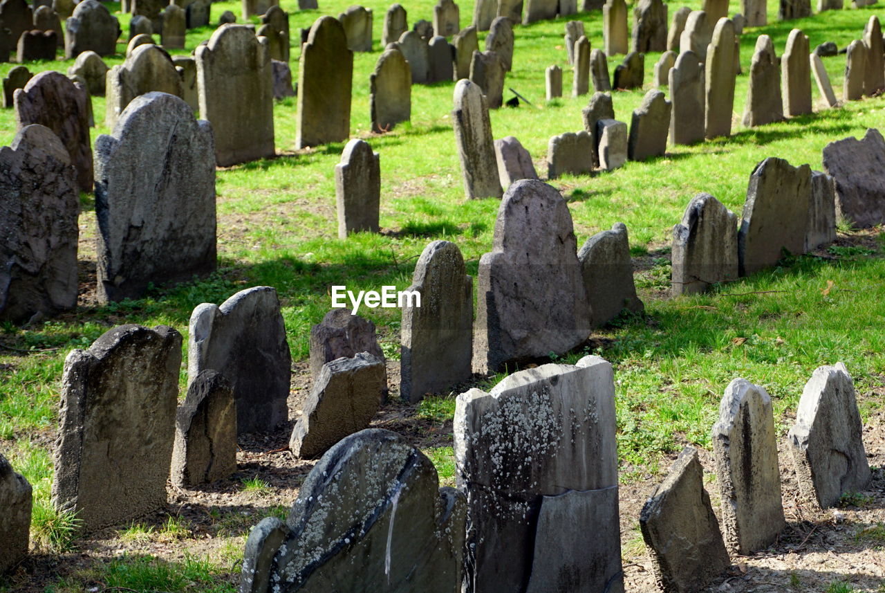 High angle view of tombstones on field in cemetery