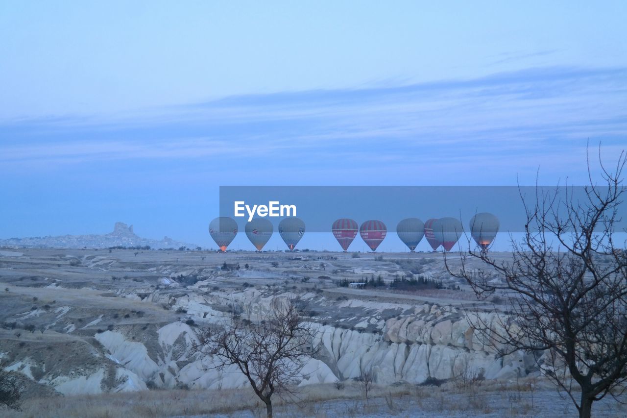 Hot air balloons at cappadocia against sky