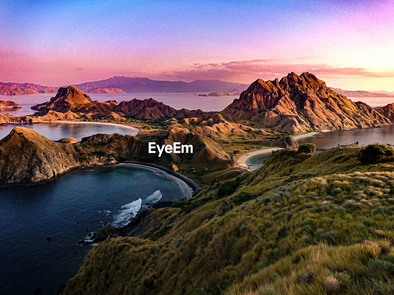 Scenic view of river by mountains against sky during sunset