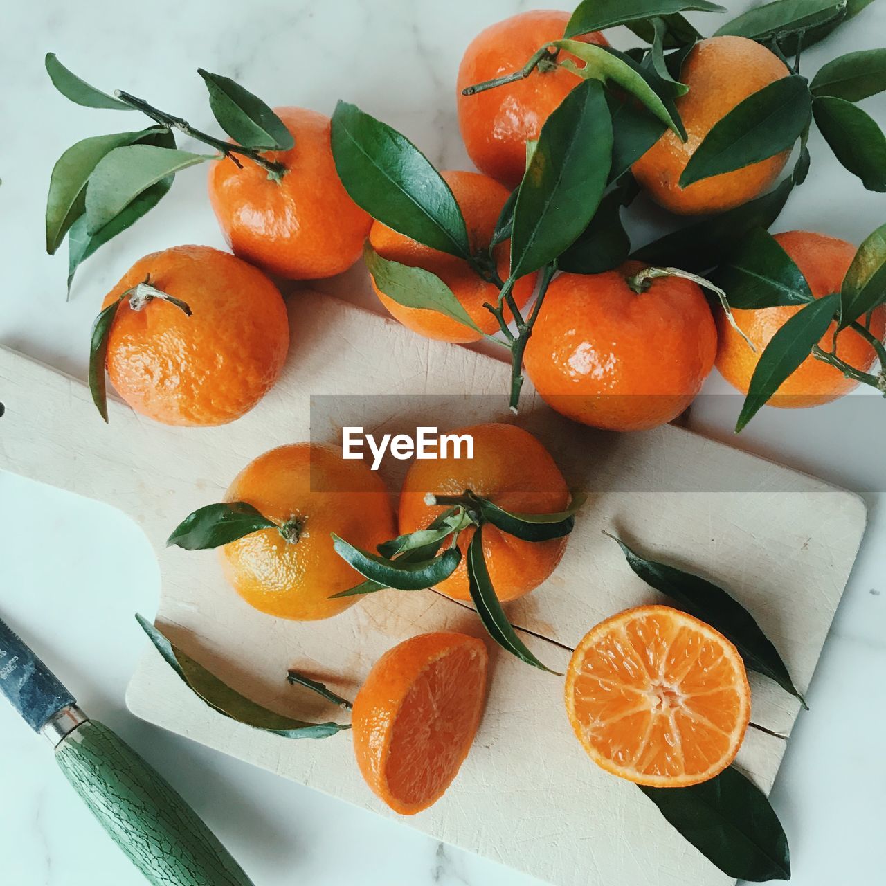 Close-up of orange fruits and kitchen knife on table