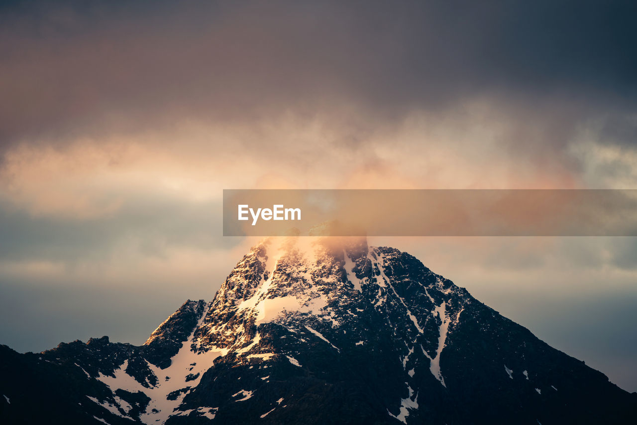 Scenic view of snowcapped mountains against sky during sunset