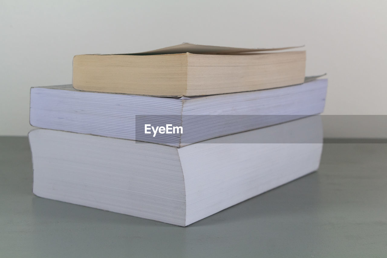 Close-up of books on table against white background