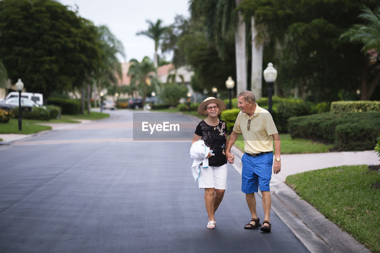 Senior couple walking hand in hand enjoying retirement