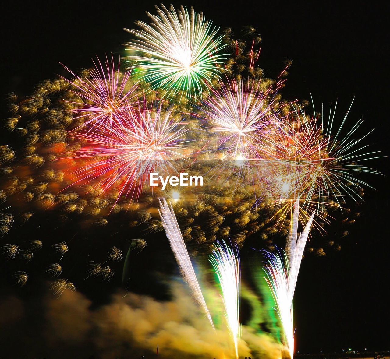 Low angle view of firework display at night