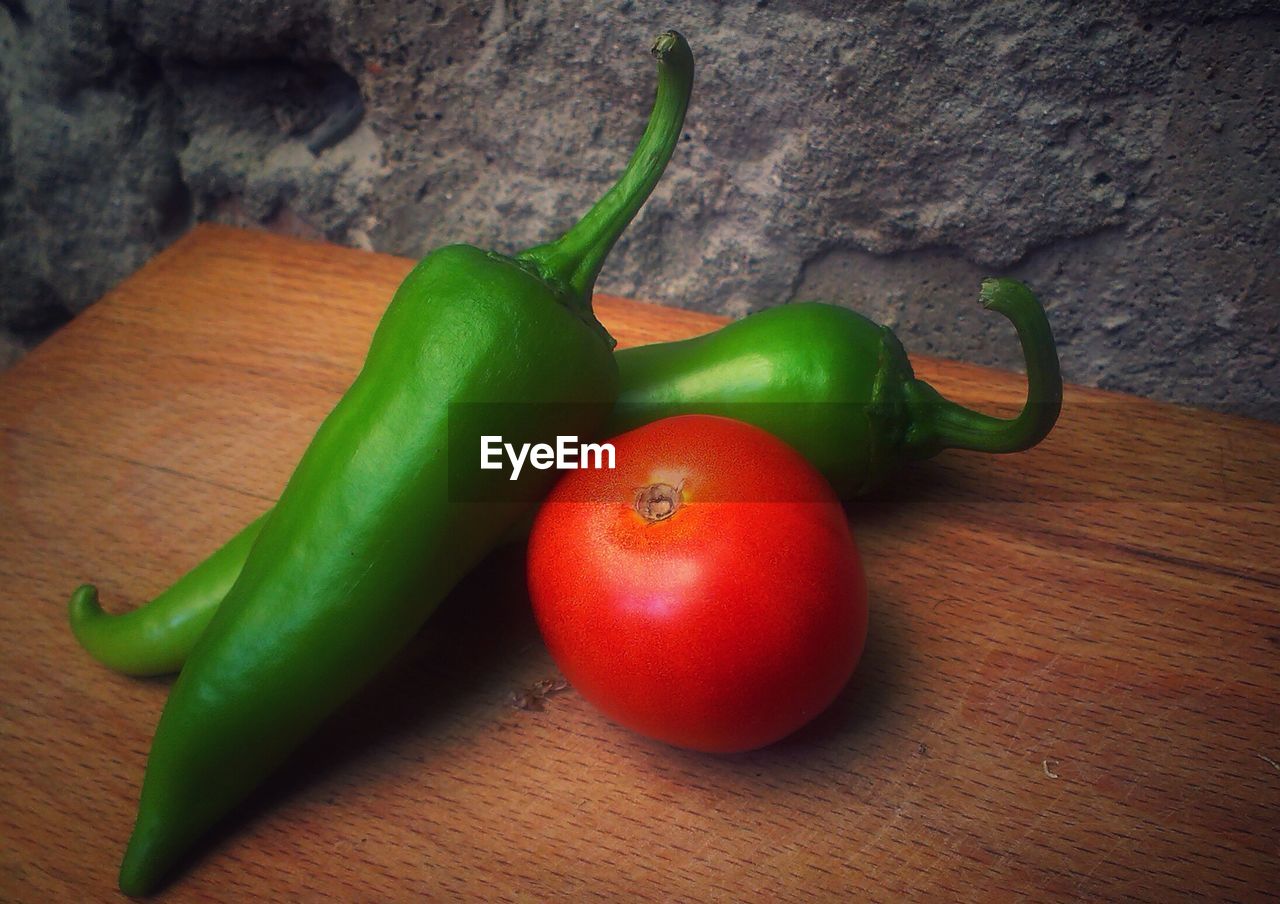 HIGH ANGLE VIEW OF RED CHILI PEPPERS ON TABLE