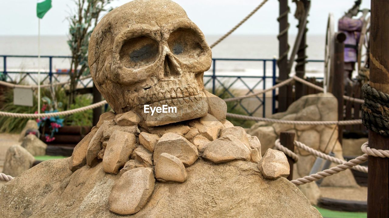 Close-up of skull statue at crazy golf