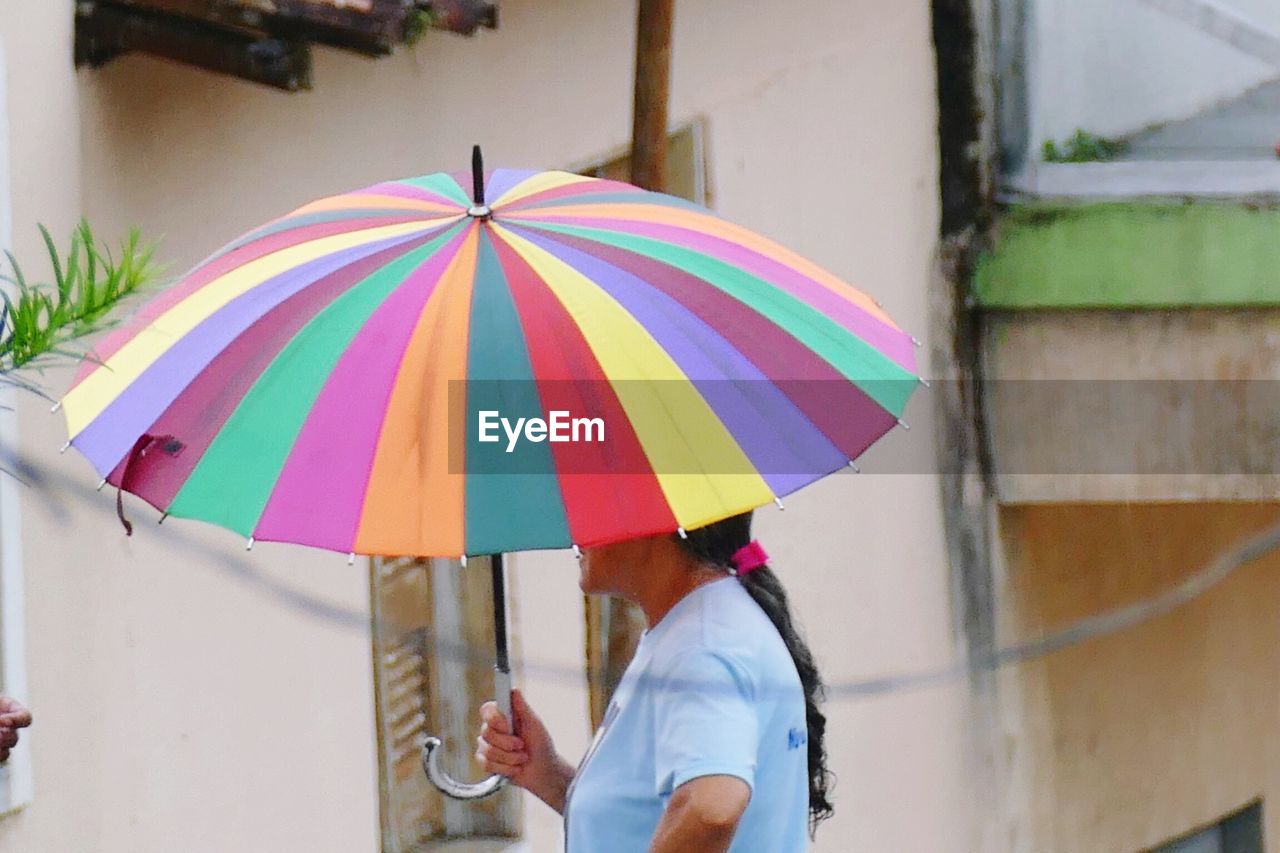 MULTI COLORED UMBRELLA HOLDING COLORFUL UMBRELLAS