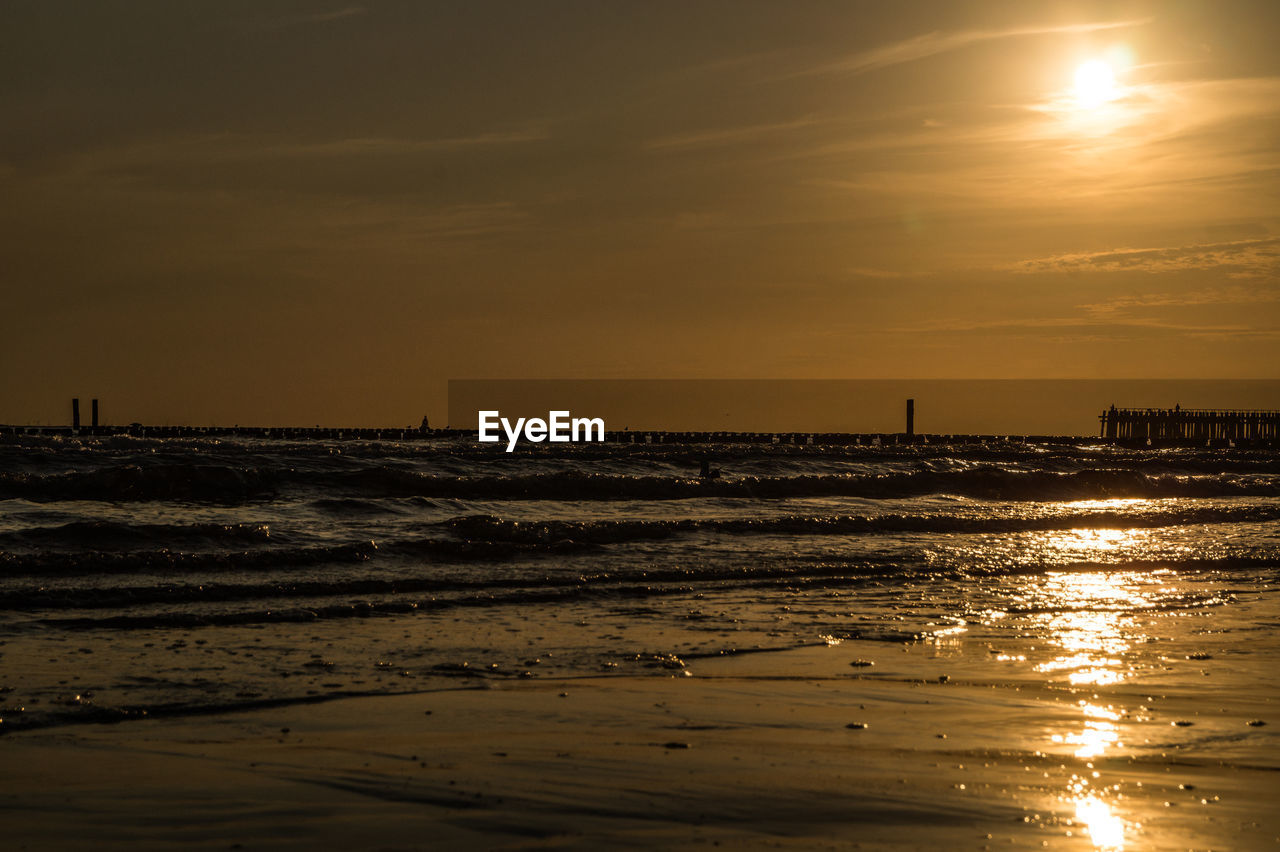 Scenic view of sea against sky at sunset