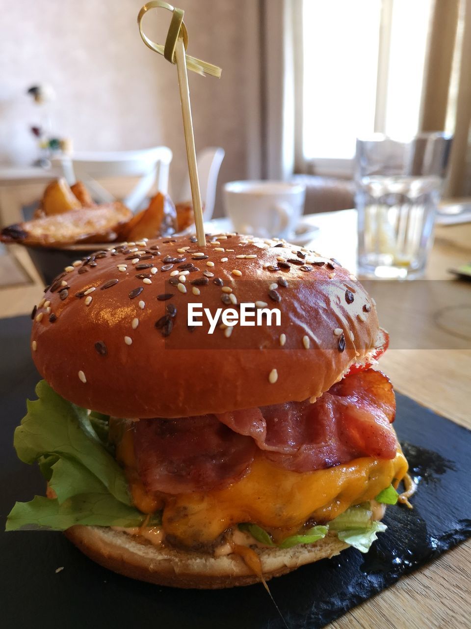 CLOSE-UP OF BURGER ON TABLE