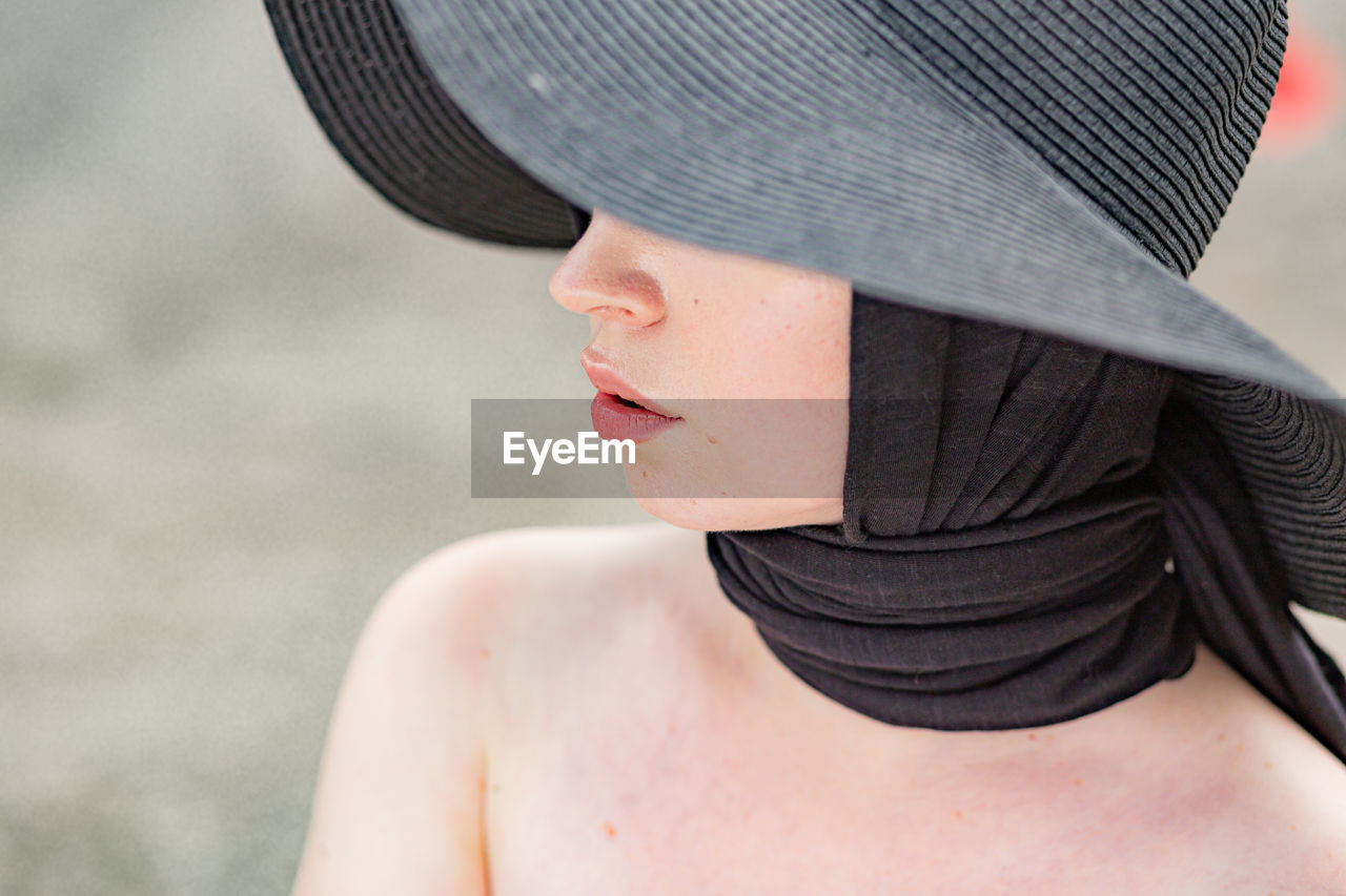 Close-up of woman wearing black hat