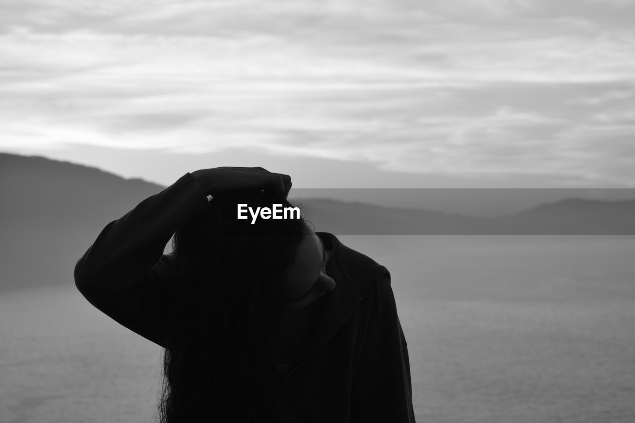 SILHOUETTE OF MAN STANDING ON MOUNTAIN