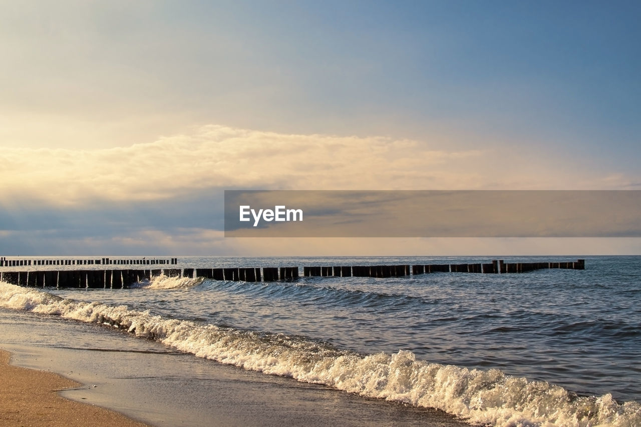 PIER OVER SEA AGAINST SKY AT SUNSET