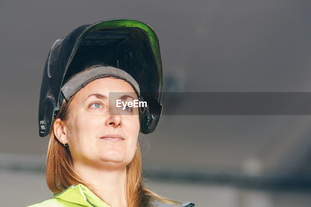 Female worker wearing welding mask