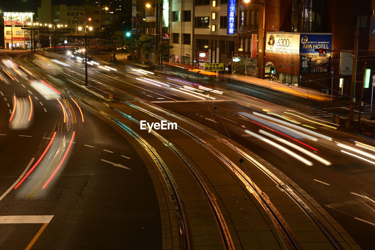 HIGH ANGLE VIEW OF LIGHT TRAILS ON ROAD IN CITY