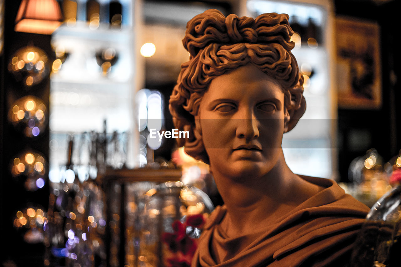 Close-up of male statue in illuminated bar