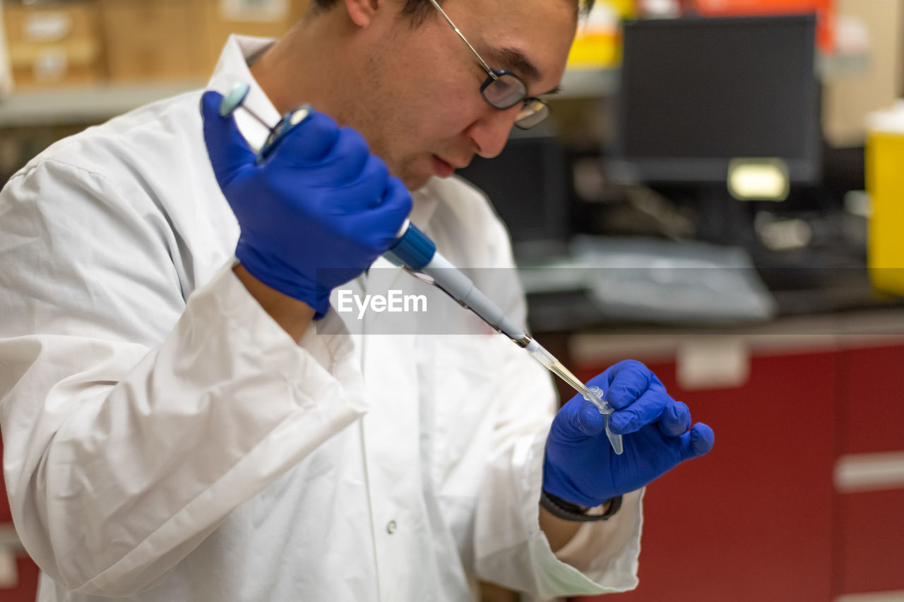 Scientist analyzing chemical in library