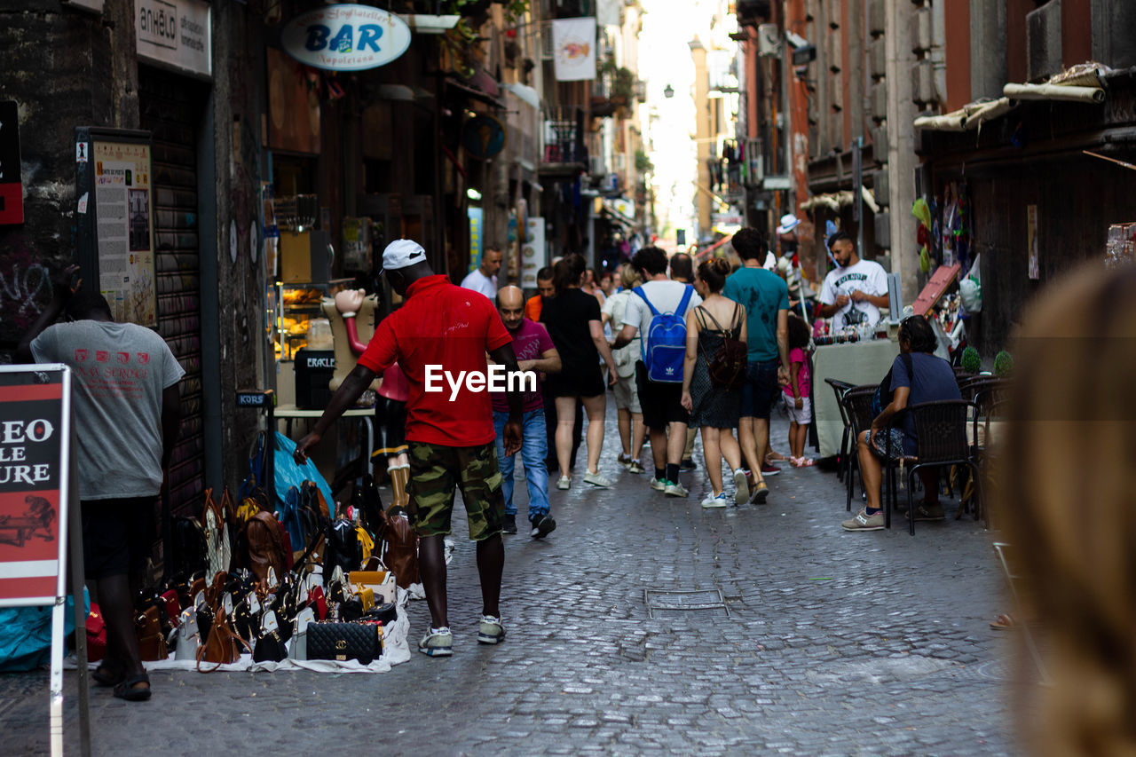 PEOPLE WALKING ON STREET IN MARKET