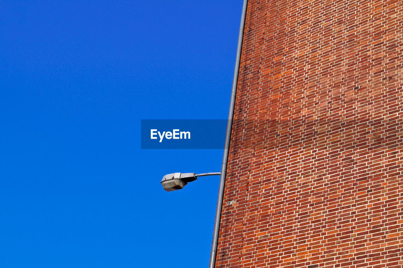 Low angle view of building against clear blue sky