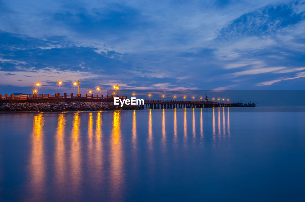 Illuminated pier at dusk