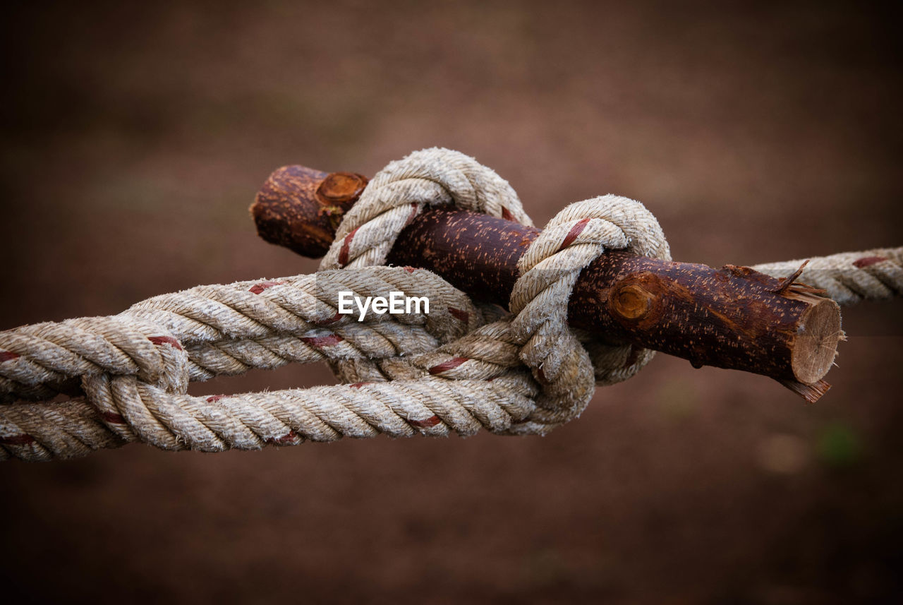 Close-up of rope tied on rusty metal