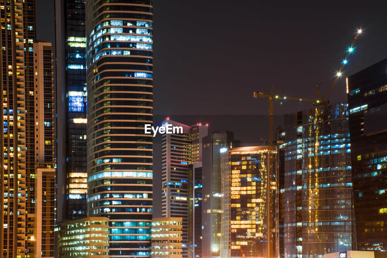 Illuminated buildings in city at night