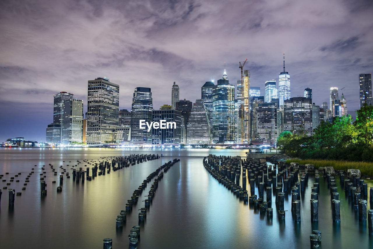 Manhattan glows across east river nyc