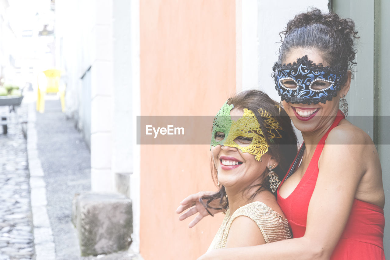 Portrait of two women wearing venice carnival mask. 