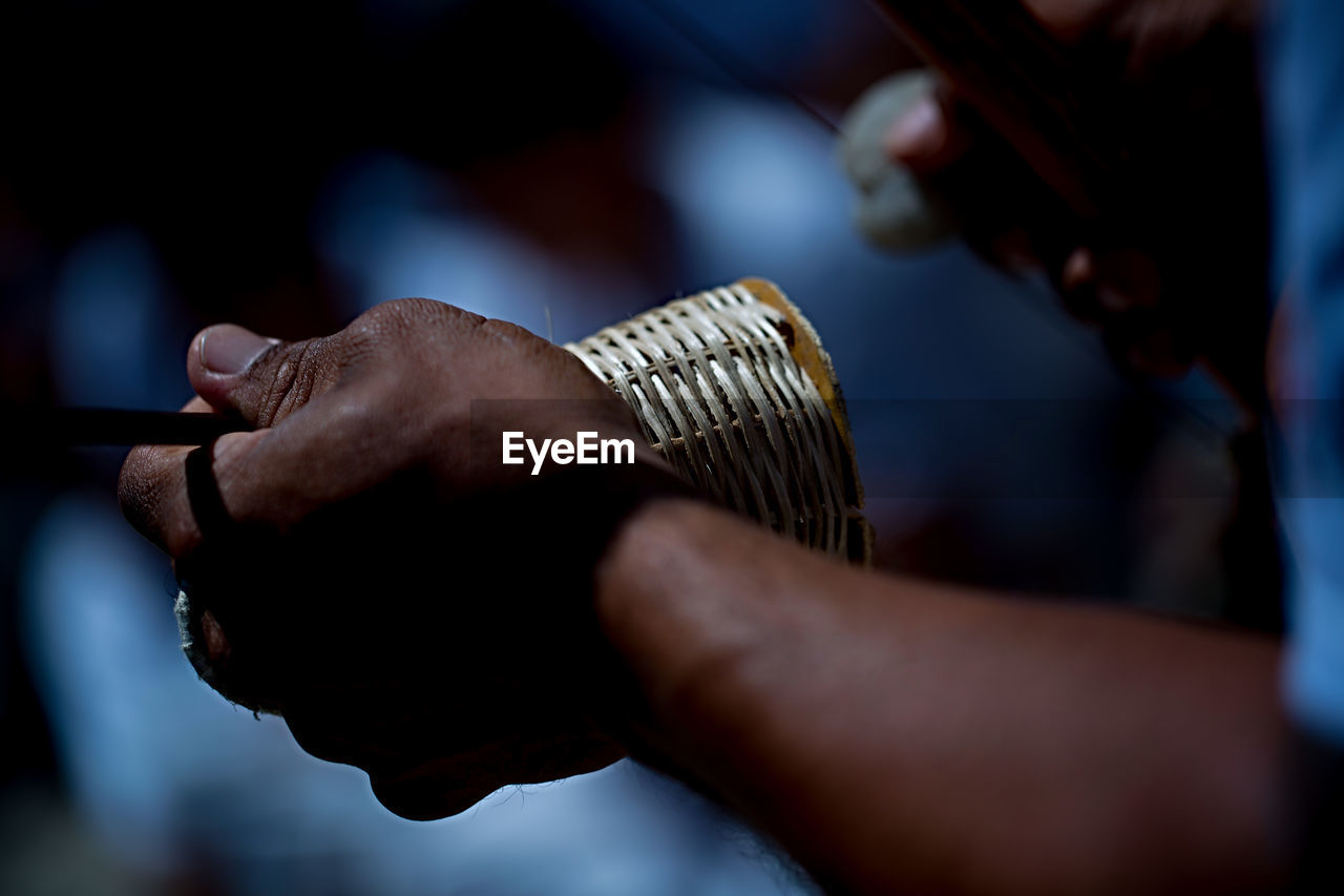 Cropped hands playing music instrument