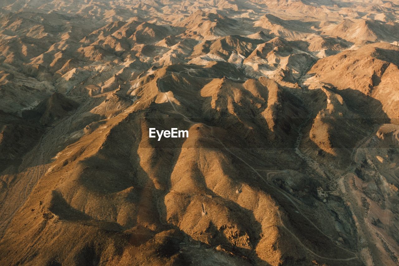 HIGH ANGLE VIEW OF STONES AND LAND IN SUNLIGHT