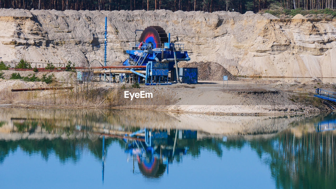 Reflection of goldmining plant in lake