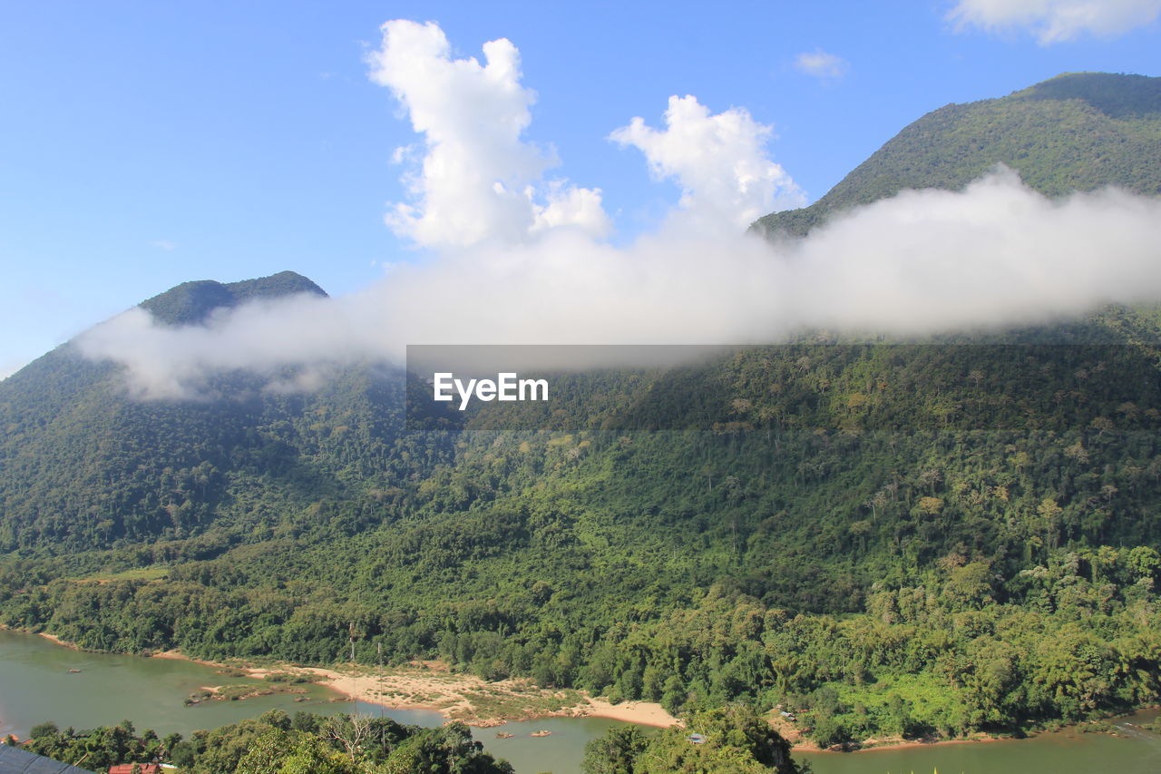 SCENIC VIEW OF WATERFALL AGAINST SKY