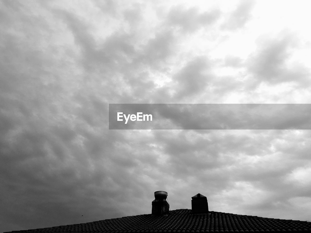Low angle view of building against cloudy sky